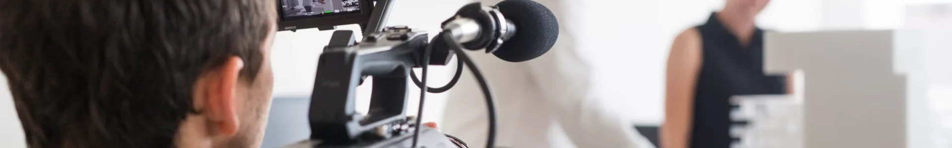 rear-view-of-photographer-video-recording-business-2026-01-05-05-00-12-utc