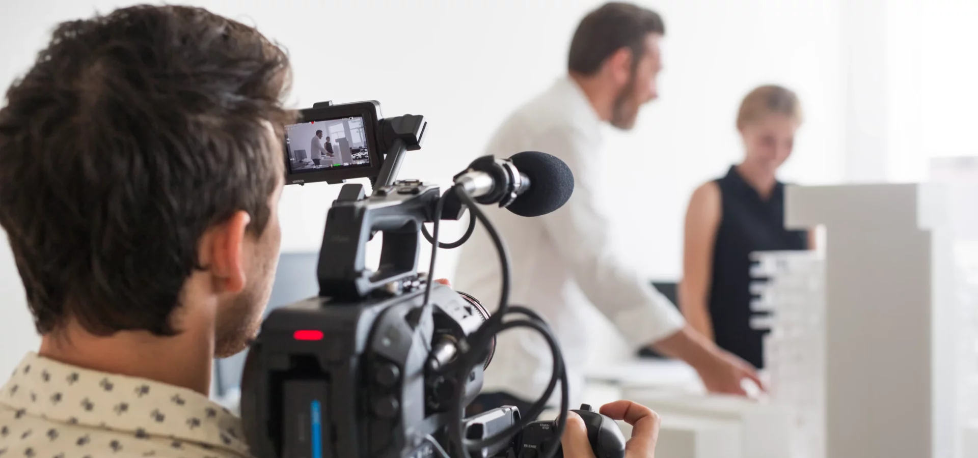 rear-view-of-photographer-video-recording-business-2026-01-05-05-00-12-utc